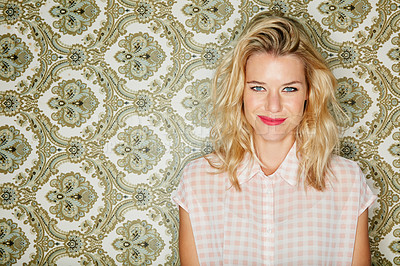 Buy stock photo Shot of a young woman posing against a wallpaper background