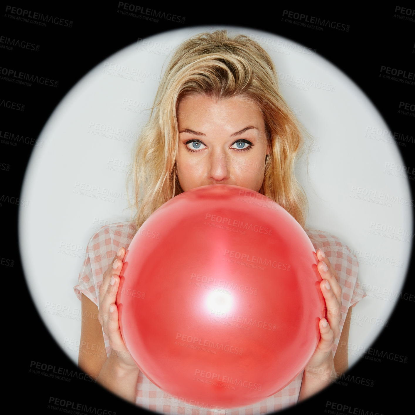 Buy stock photo Cropped shot of a beautiful young woman inflating a balloon