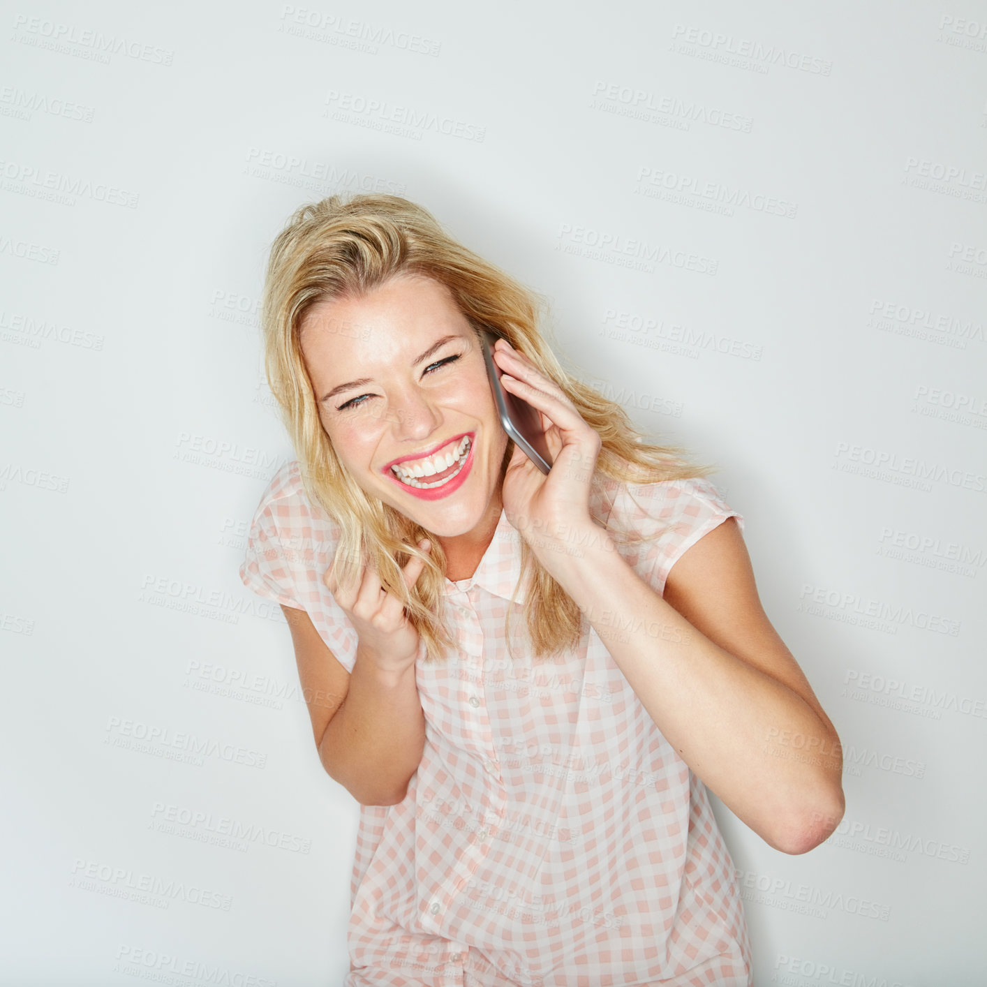 Buy stock photo Studio shot of a young woman using her cellphone