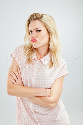 Buy stock photo Cropped shot of a young woman sulking against a white background