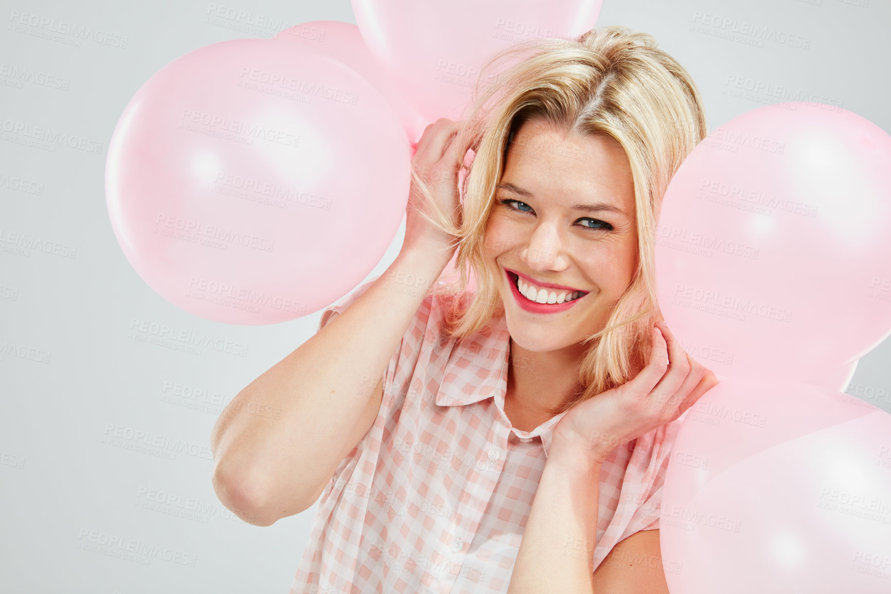 Buy stock photo Cropped shot of a beautiful young woman posing with pink balloons