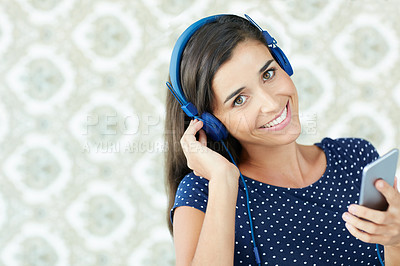 Buy stock photo Portrait of an attractive young woman listening to music