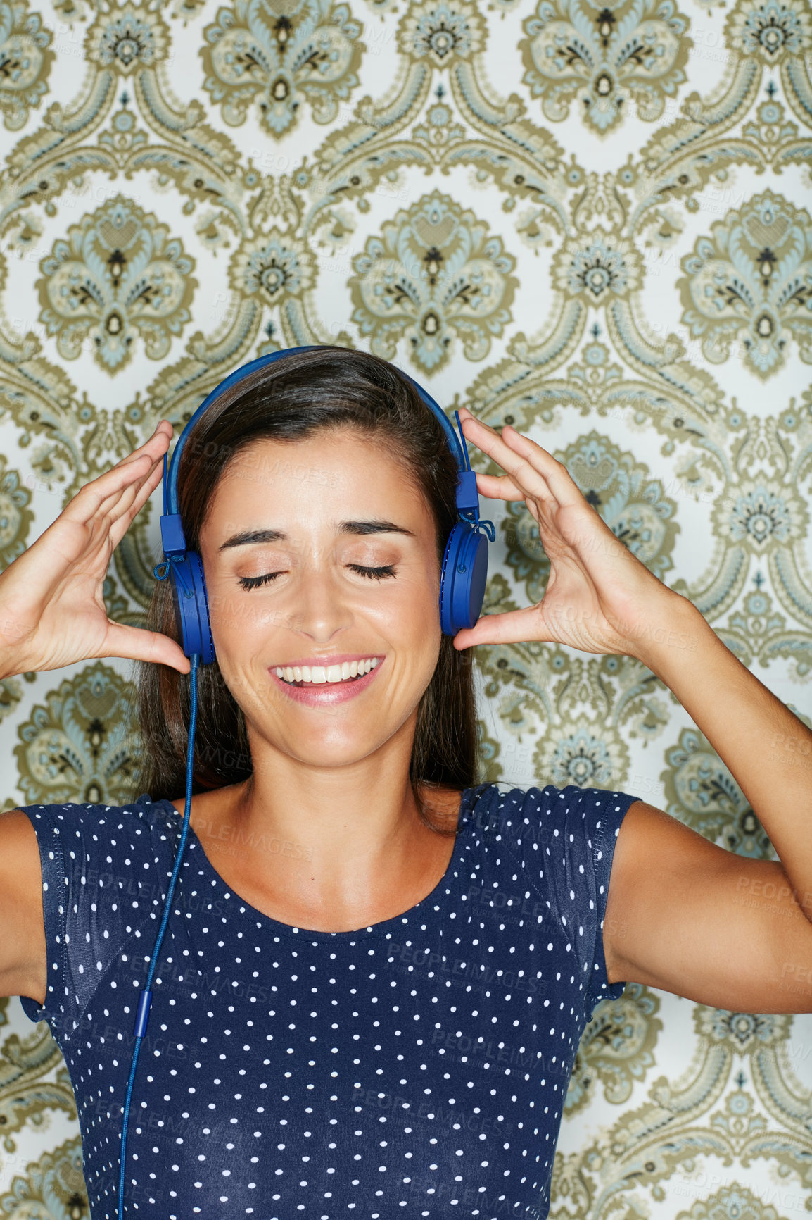 Buy stock photo Shot of an attractive young woman listening to music