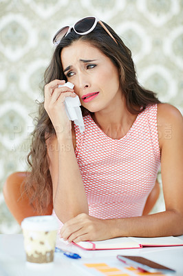 Buy stock photo Cropped shot of a young woman reading an emotional text message