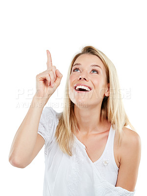 Buy stock photo Studio shot of an amazed young woman pointing at copyspace against a white background