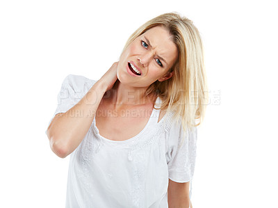 Buy stock photo Studio portrait of a young woman experiencing neck ache against a white background