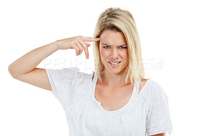 Buy stock photo Studio shot of a young woman pointing her fingers at herself in annoyance against a white background