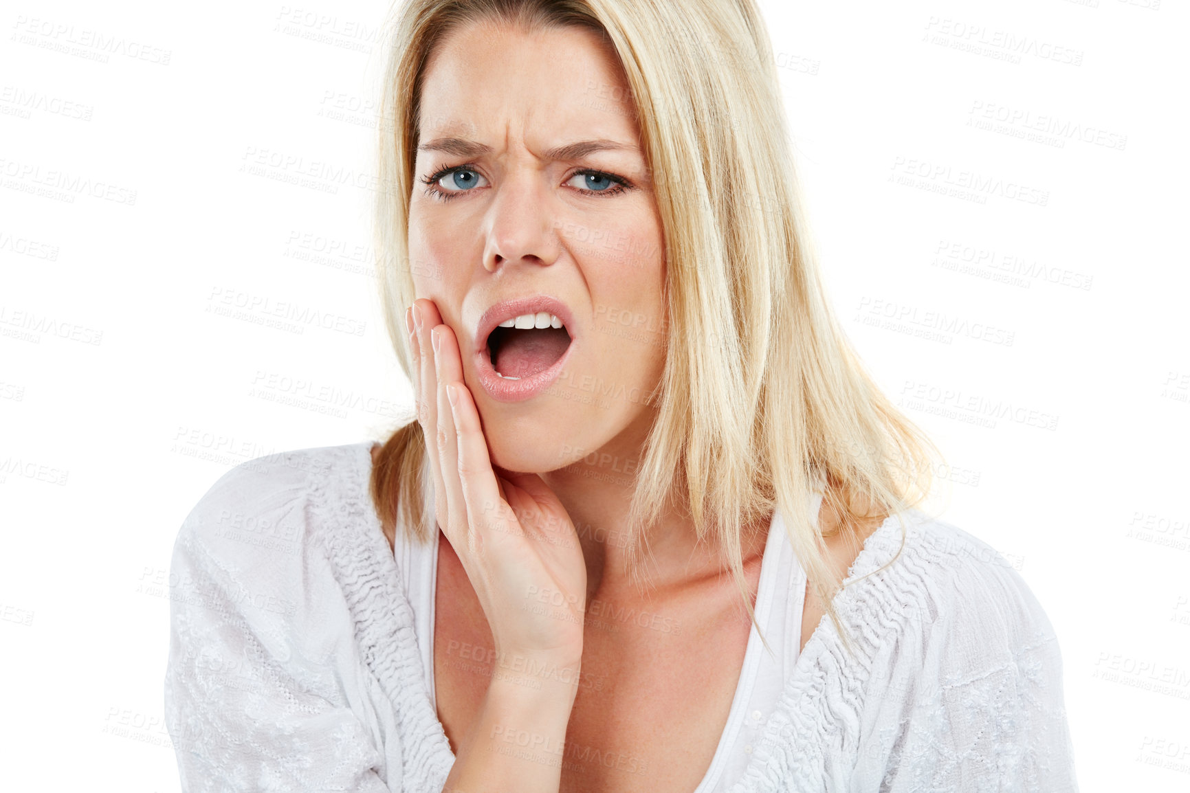 Buy stock photo Studio portrait of a young woman experiencing toothache against a white background