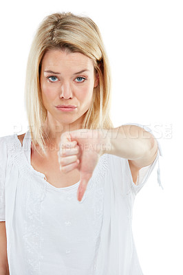 Buy stock photo Studio portrait of a young woman giving thumbs down against a white background