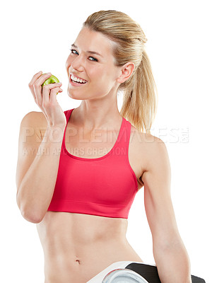 Buy stock photo Studio shot of an athletic young woman eating an apple