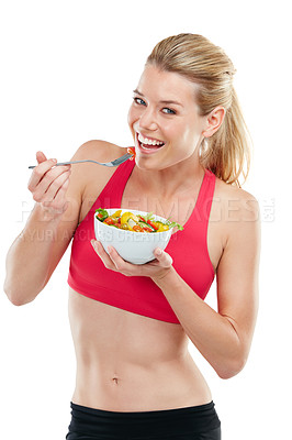 Buy stock photo Studio shot of an athletic young woman eating a bowl of salad