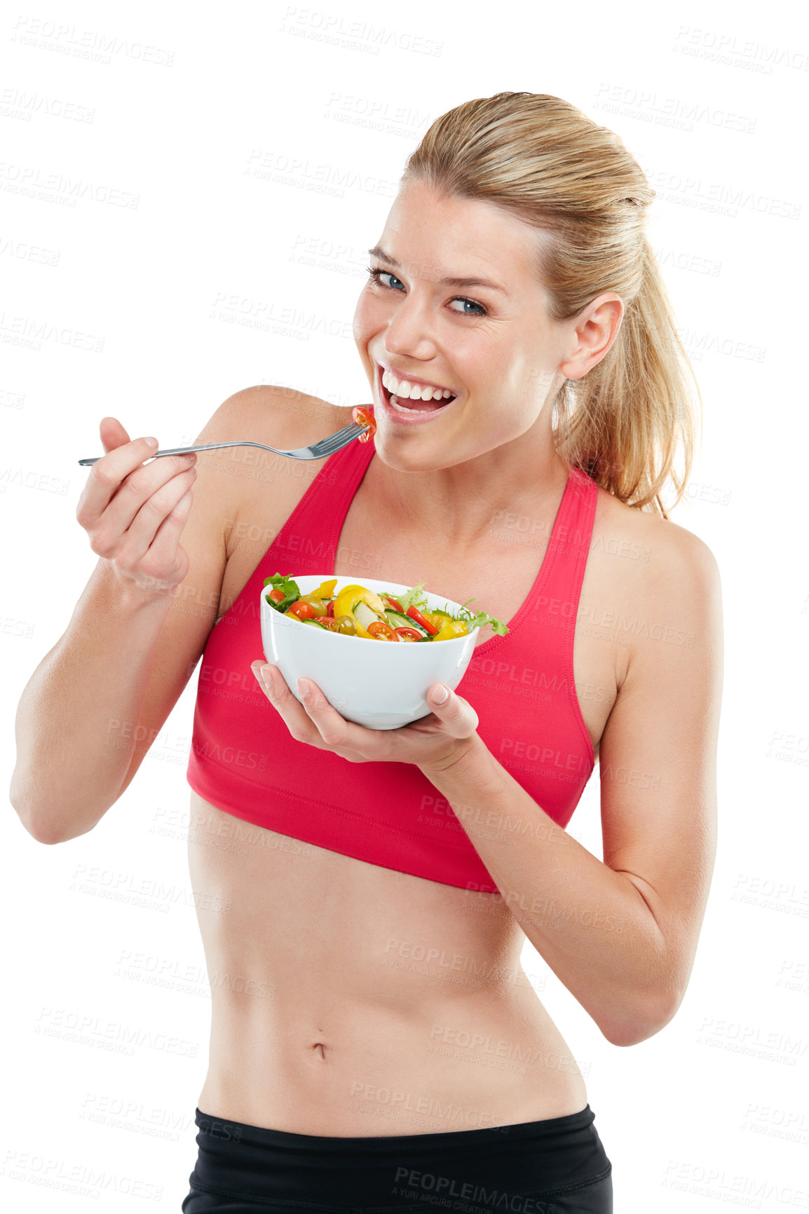 Buy stock photo Studio shot of an athletic young woman eating a bowl of salad