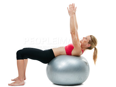 Buy stock photo Studio shot of a young woman working out with her exercise ball