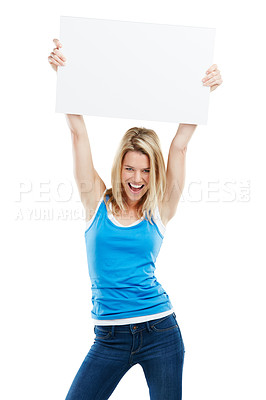 Buy stock photo Studio shot of an attractive young woman holding up a blank placard