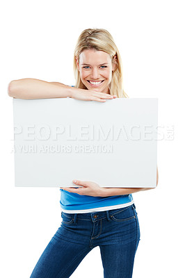 Buy stock photo Studio shot of an attractive young woman holding up a blank placard