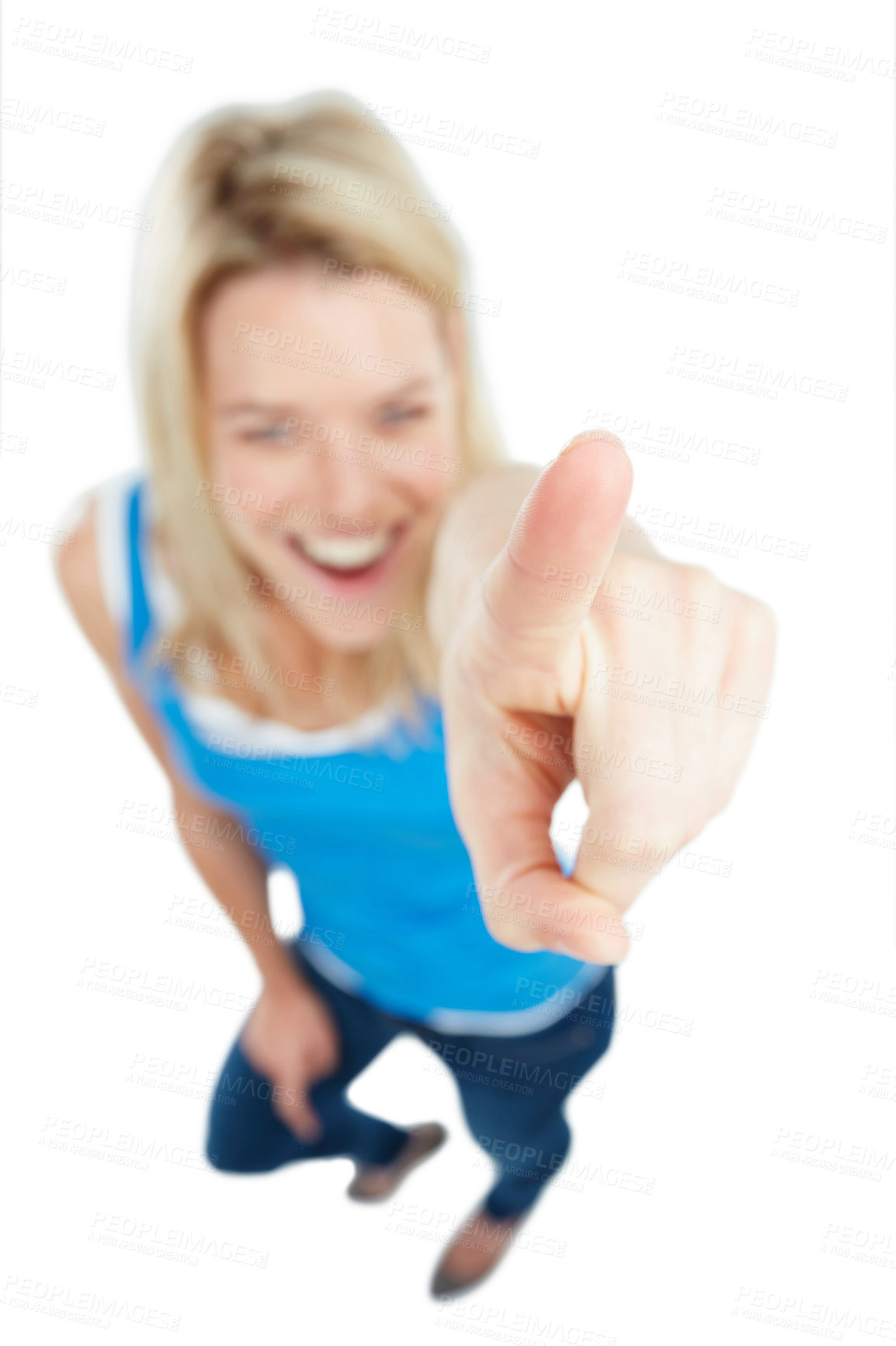 Buy stock photo Studio shot of a young woman pointing towards something