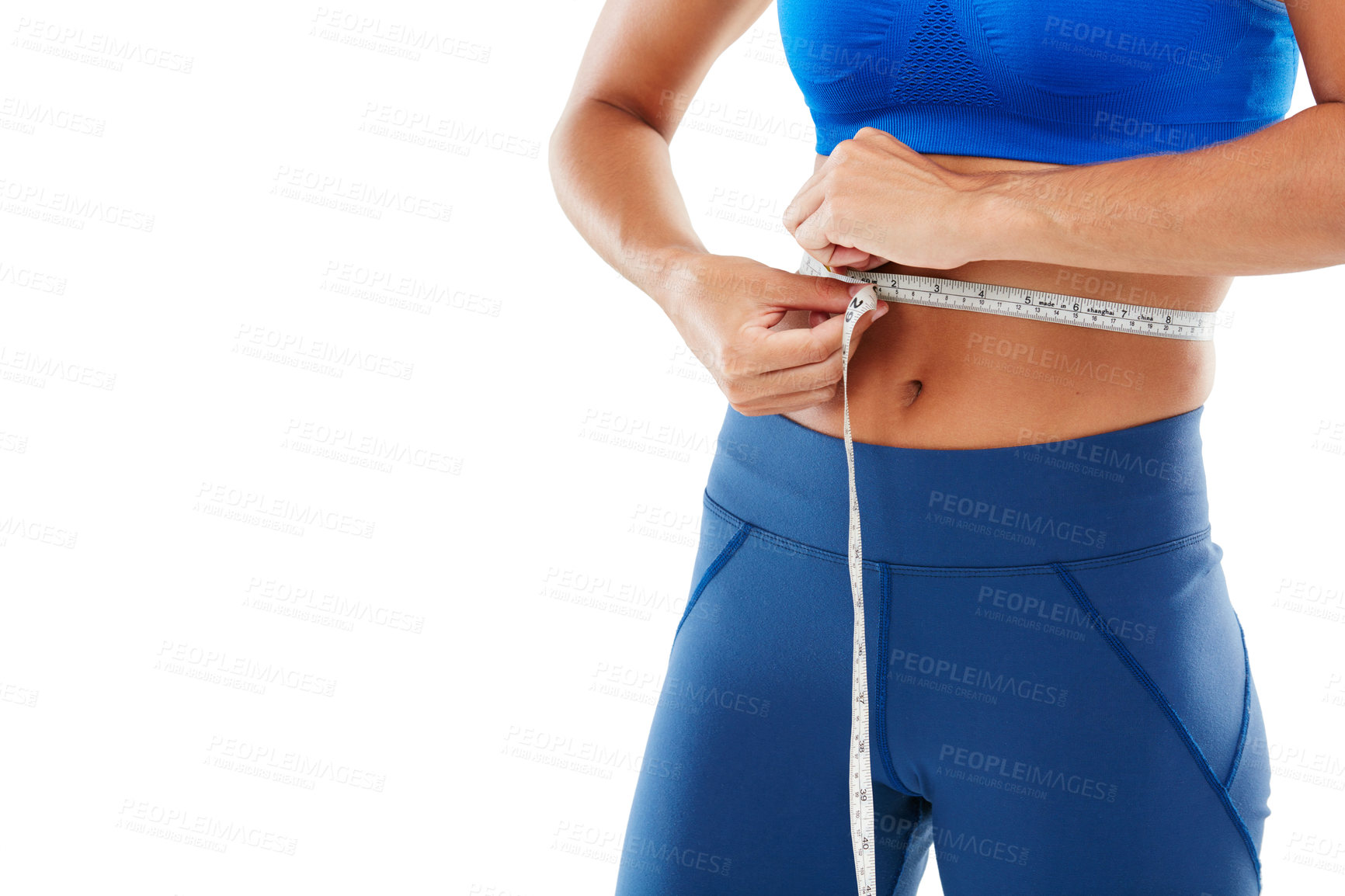 Buy stock photo Shot of a sporty young woman measuring her waist against a white background