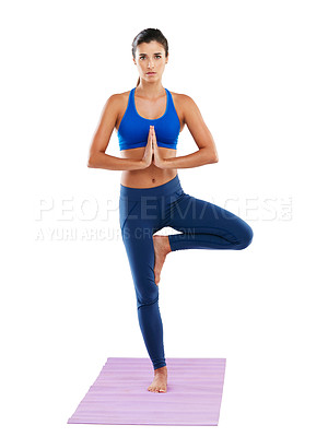 Buy stock photo Portrait of a sporty young woman practicing yoga against a white background