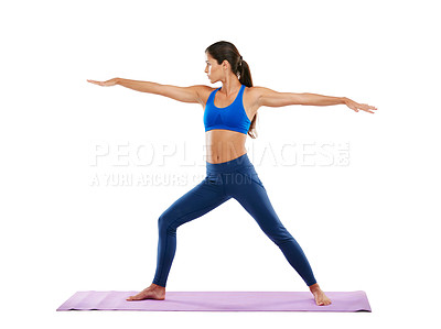 Buy stock photo Shot of a sporty young woman practicing yoga against a white background