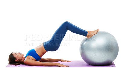 Buy stock photo Shot of a sporty young woman practising yoga against a white background