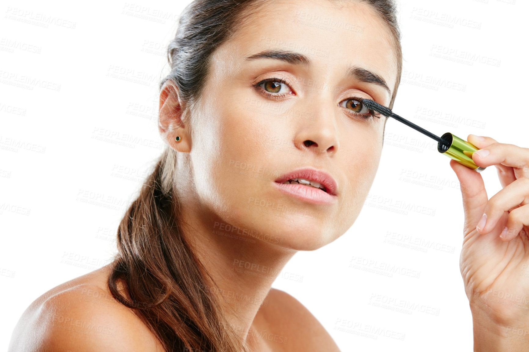 Buy stock photo Studio portrait of a beautiful young woman applying mascara against a white background