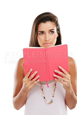 Buy stock photo Studio shot of a thoughtful young woman reading a book against a white background