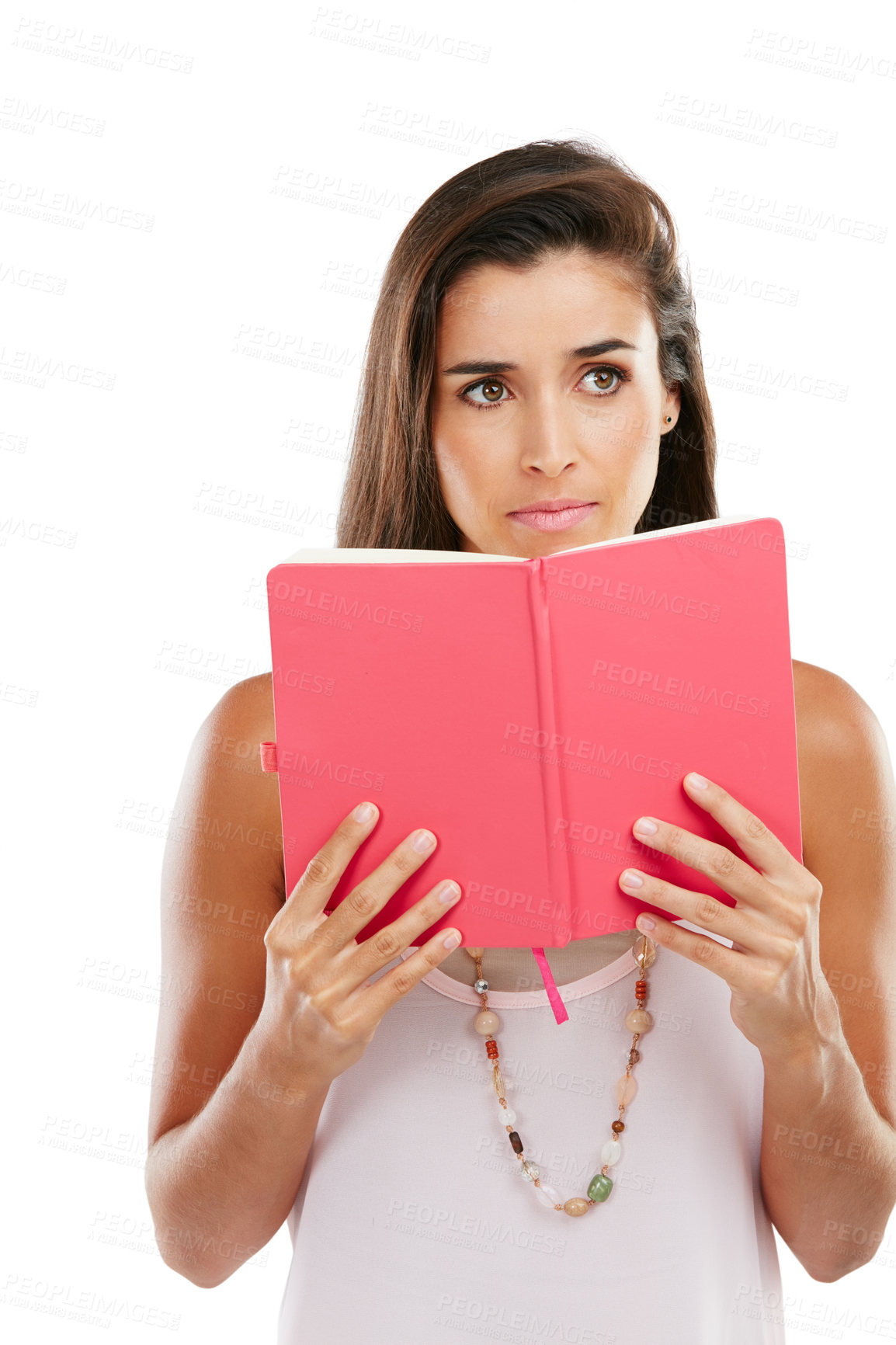 Buy stock photo Studio shot of a thoughtful young woman reading a book against a white background