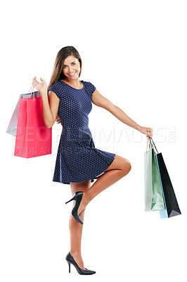 Buy stock photo Studio portrait of an attractive young woman carrying shopping bags against a white background