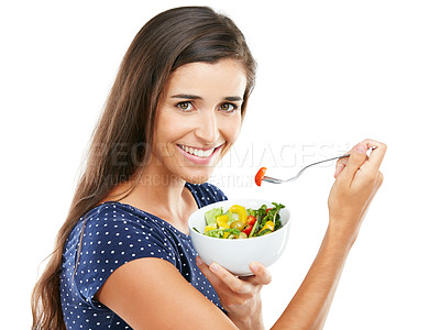 Buy stock photo Studio portrait of an attractive young woman eating a healthy salad against a white background