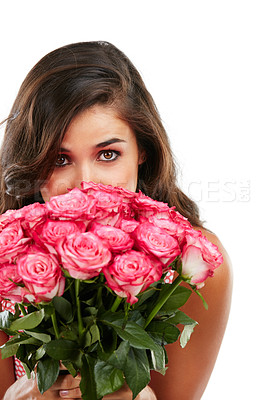 Buy stock photo Studio portrait of a young woman holding a bouquet of flowers against a white background