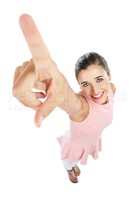 Buy stock photo High angle studio portrait of a happy young woman pointing against a white background