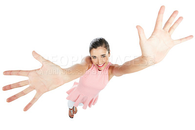 Buy stock photo High angle studio portrait of an attractive young woman with her arms raised against a white background