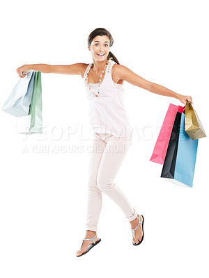 Buy stock photo Studio portrait of a happy young woman carrying shopping bags against a white background