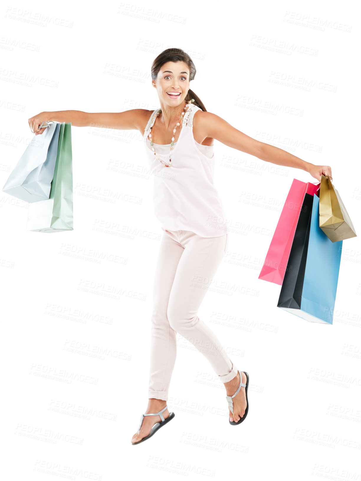 Buy stock photo Studio portrait of a happy young woman carrying shopping bags against a white background