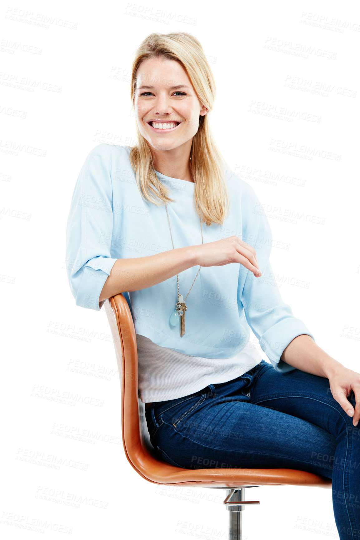 Buy stock photo Studio portrait of a happy young woman sitting on a chair against a white background