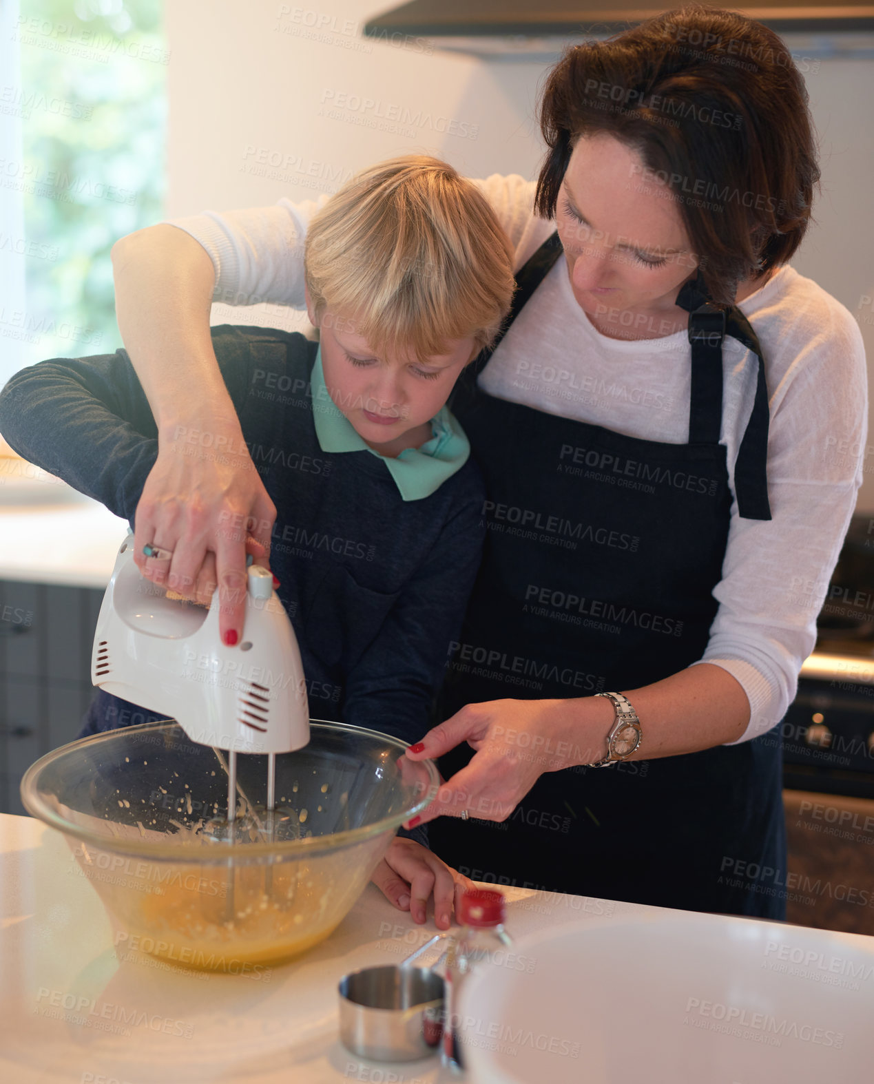Buy stock photo Mother, teaching and cooking with child in kitchen for bonding, learning and growth with family. Boy, mixer and baking for dinner preparation at home, support and care or love for healthy food