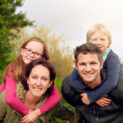 Buy stock photo Portrait of a young family standing outside together