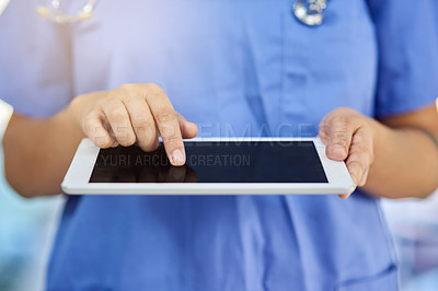 Buy stock photo Closeup shot of a medical practitioner using a digital tablet