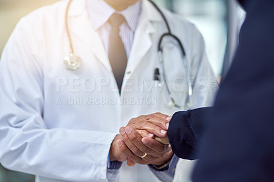 Buy stock photo Cropped shot of a doctor holding a patient's hand in comfort