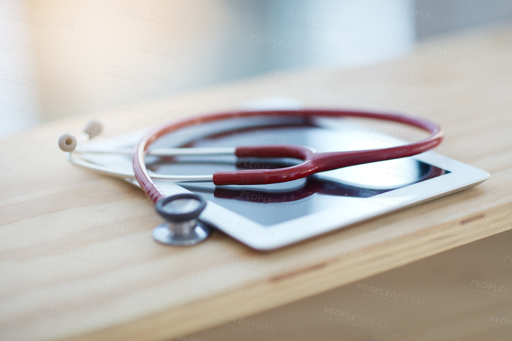 Buy stock photo Closeup shot of a digital tablet and a stethoscope on a table