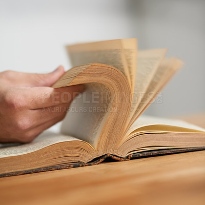 Buy stock photo Cropped shot of an unidentifiable man reading a book