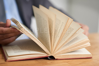 Buy stock photo Cropped shot of an unidentifiable man reading a book