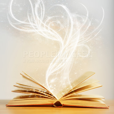 Buy stock photo Shot of an open book with sparkles coming out of it