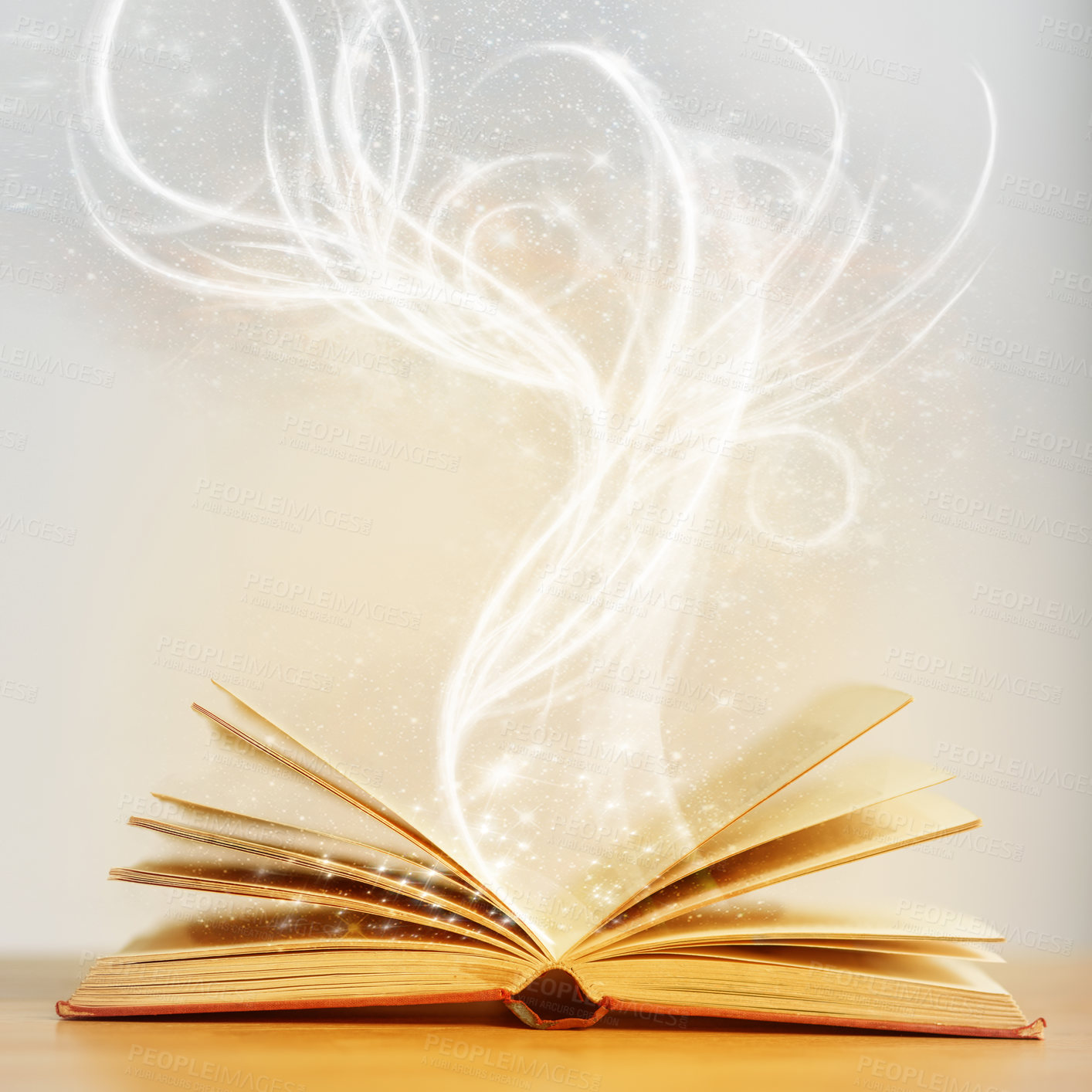 Buy stock photo Shot of an open book with sparkles coming out of it