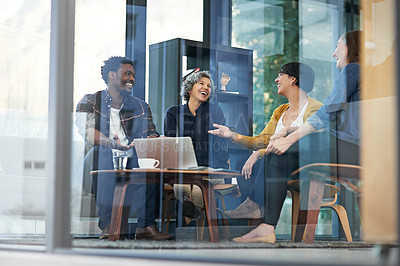 Buy stock photo Shot of a team of creative businesspeople brainstorming around a laptop in the office