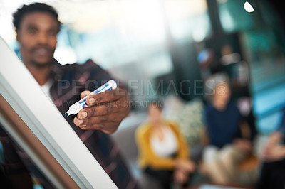 Buy stock photo Shot of a creative businessman giving a presentation to his colleagues in the office