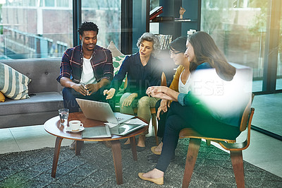 Buy stock photo Shot of a team of creative businesspeople brainstorming around a laptop in the office