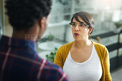 Buy stock photo Shot of two designers having a disagreement in the office