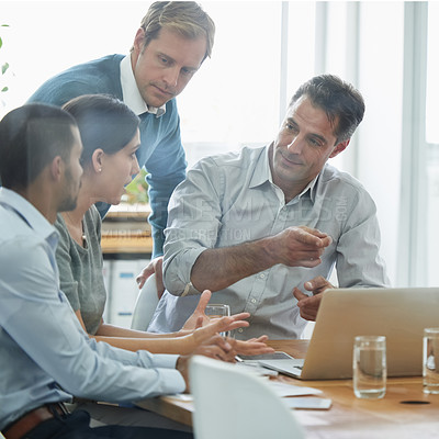 Buy stock photo Shot of a group of professionals using wireless technology during a meeting