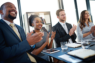 Buy stock photo Shot of a group of corporate businesspeople applauding while sitting in the boardroom